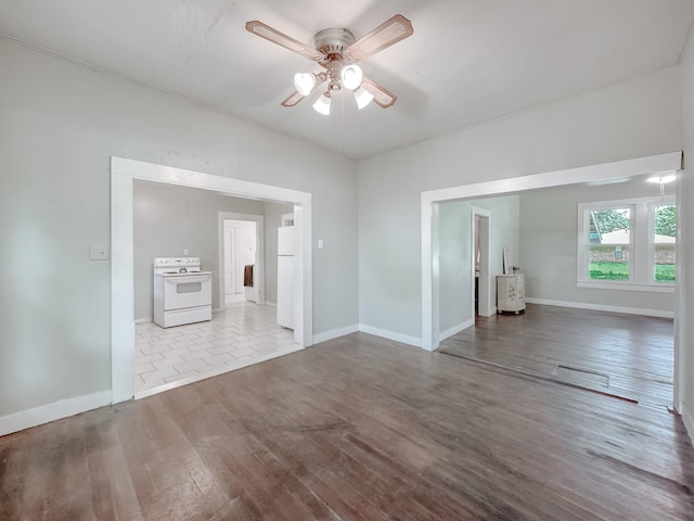 408 S Throckmorton Ave, Kerens, TX 75144 - unfurnished living room with a ceiling fan and wood finished floors