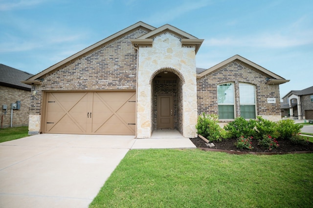 6428 Wales St, Celina, TX 76227 - french country home with brick siding, concrete driveway, a garage, and a front yard