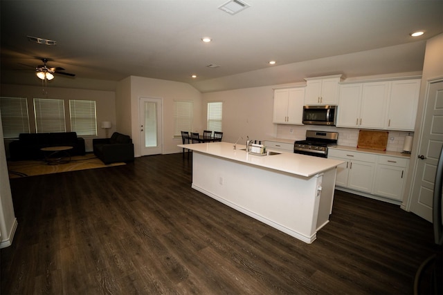 6428 Wales St, Celina, TX 76227 - kitchen with appliances with stainless steel finishes, dark wood-type flooring, decorative backsplash, white cabinets, and recessed lighting