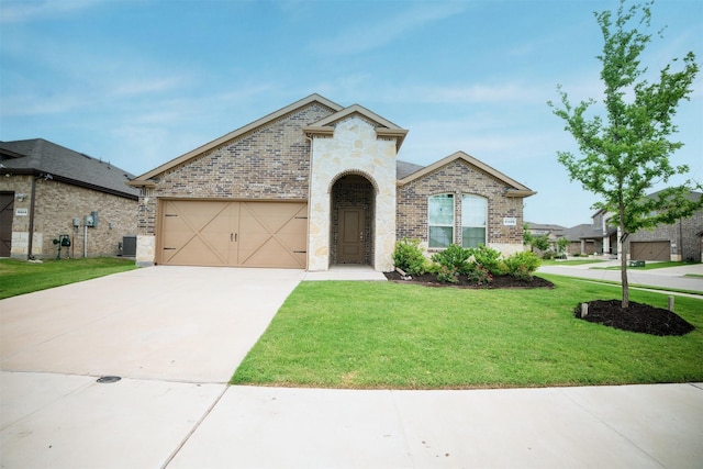 6428 Wales St, Celina, TX 76227 - french country home with brick siding, a front lawn, concrete driveway, and an attached garage
