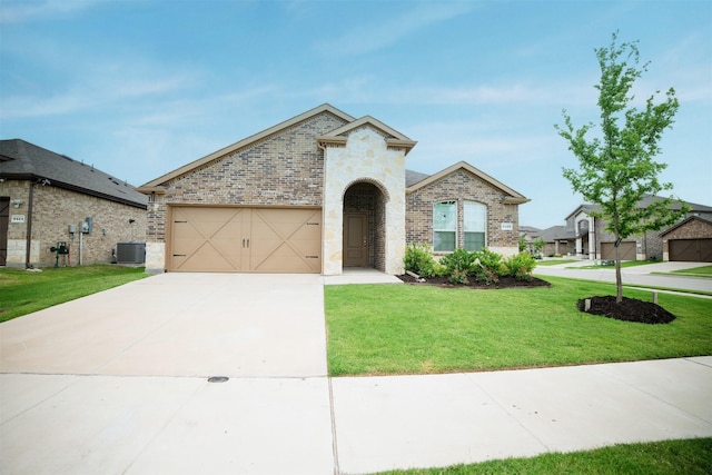 6428 Wales St, Celina, TX 76227 - french country style house featuring a front lawn, brick siding, driveway, a garage, and stone siding