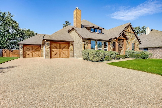 1023 Winding Creek Dr, Kennedale, TX 76060 - view of front facade featuring stone siding, a chimney, a garage, driveway, and roof with shingles
