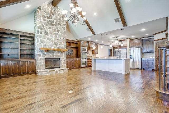 1023 Winding Creek Dr, Kennedale, TX 76060 - unfurnished living room featuring a chandelier, a stone fireplace, wood finished floors, beam ceiling, and high vaulted ceiling