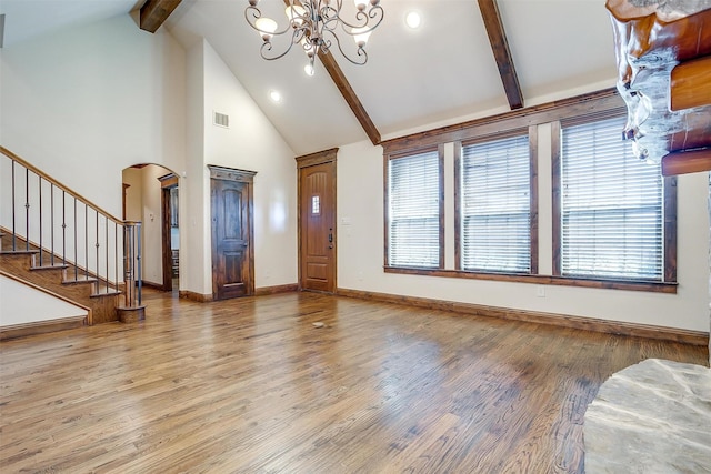 1023 Winding Creek Dr, Kennedale, TX 76060 - entryway featuring high vaulted ceiling, beam ceiling, a chandelier, arched walkways, and wood finished floors