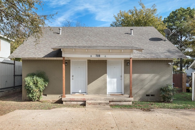 709 N Pecan St, Arlington, TX 76011 - view of front of house with roof with shingles, brick siding, and crawl space