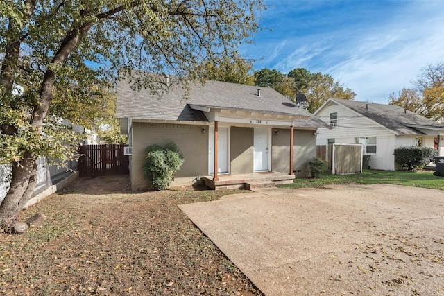709 N Pecan St, Arlington, TX 76011 - back of house with brick siding, roof with shingles, and a gate