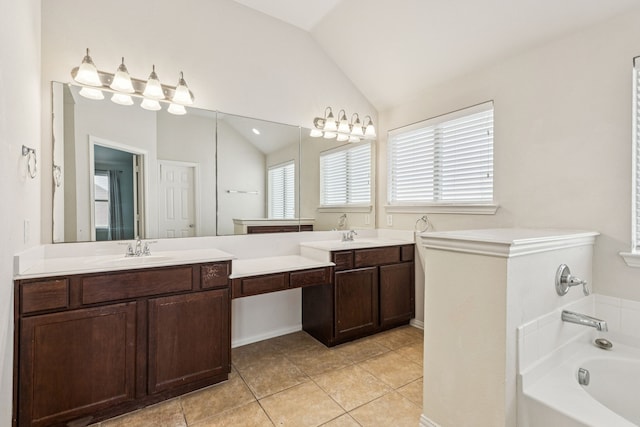 326 Blackhaw Dr, Fate, TX 75087 - bathroom featuring vaulted ceiling, a garden tub, double vanity, and tile patterned floors
