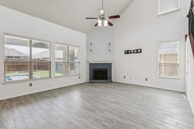 326 Blackhaw Dr, Fate, TX 75087 - unfurnished living room featuring high vaulted ceiling, a ceiling fan, a fireplace, and light wood-style flooring