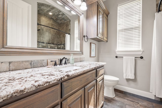 10107 Ravenswood Rd, Granbury, TX 76049 - bathroom featuring vanity, tiled shower, and wood finished floors