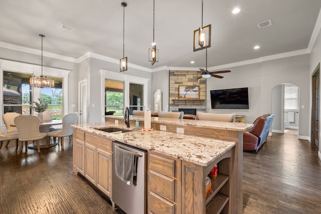 10107 Ravenswood Rd, Granbury, TX 76049 - kitchen with dishwasher, ceiling fan, a fireplace, an island with sink, and dark wood-type flooring