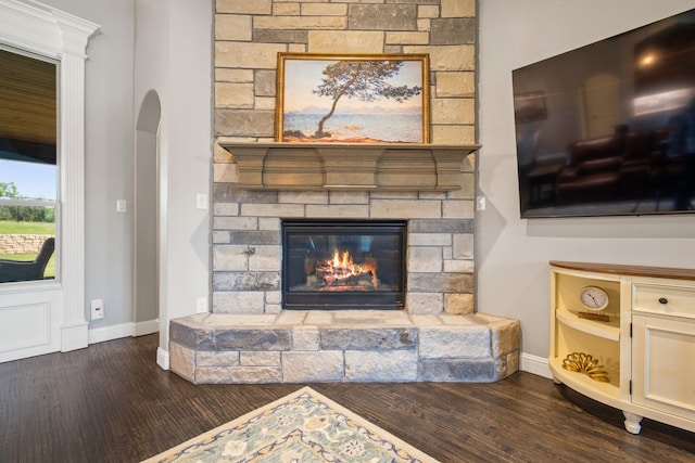 10107 Ravenswood Rd, Granbury, TX 76049 - living room with dark wood-style floors, arched walkways, and a fireplace