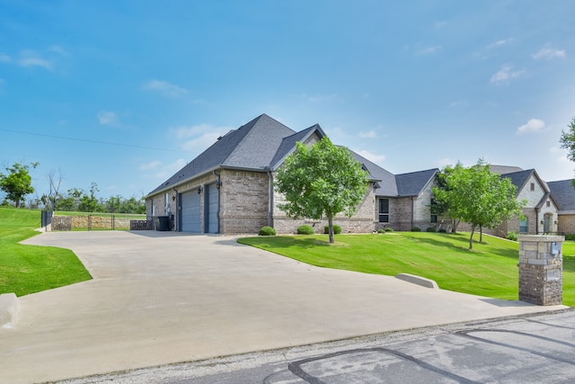 10107 Ravenswood Rd, Granbury, TX 76049 - view of front of property featuring brick siding, a garage, a front lawn, and roof with shingles
