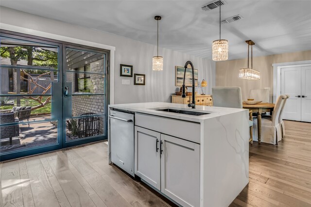 3449 W T Parr Rd W, Grapevine, TX 76051 - kitchen featuring a chandelier, stainless steel dishwasher, light wood-style floors, and decorative light fixtures