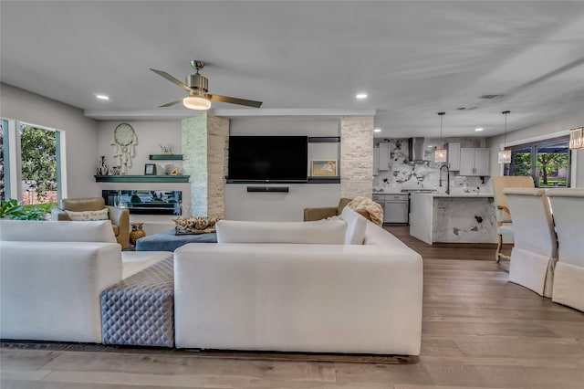 3449 W T Parr Rd W, Grapevine, TX 76051 - living room featuring plenty of natural light, recessed lighting, ceiling fan, a glass covered fireplace, and wood finished floors