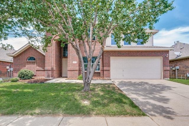 2601 Pinto Dr, Denton, TX 76210 - view of front of property featuring driveway, a front lawn, a garage, and brick siding