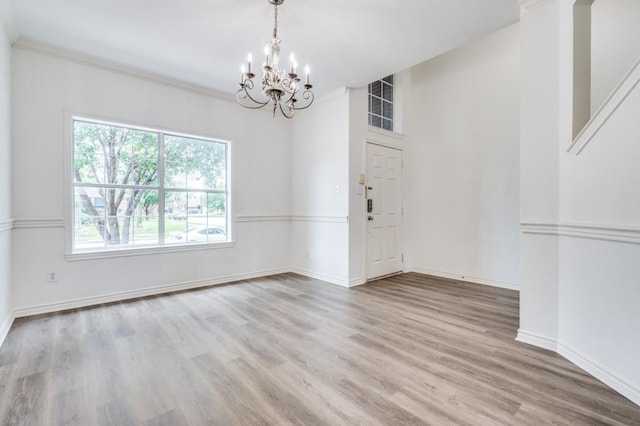 2601 Pinto Dr, Denton, TX 76210 - unfurnished dining area featuring a chandelier and wood finished floors