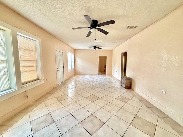 870 SW 4th St, Paris, TX 75460 - spare room featuring a ceiling fan, light tile patterned flooring, and a textured ceiling
