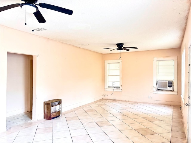870 SW 4th St, Paris, TX 75460 - empty room with ceiling fan, cooling unit, and light tile patterned flooring