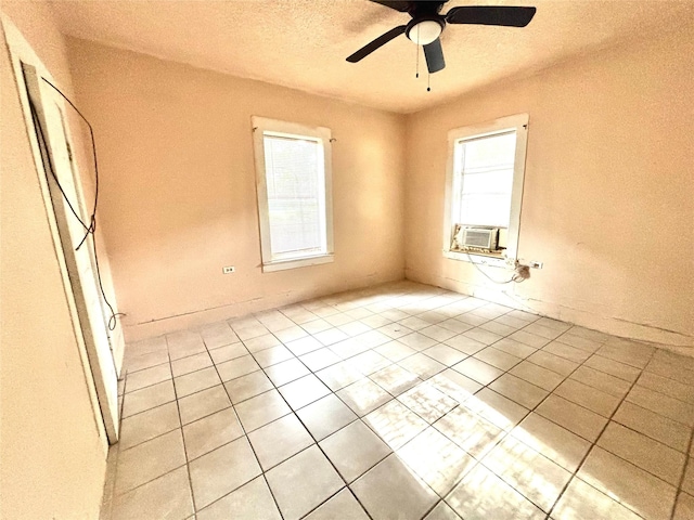 870 SW 4th St, Paris, TX 75460 - spare room featuring light tile patterned floors, a ceiling fan, cooling unit, and a textured ceiling