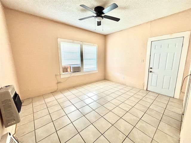 870 SW 4th St, Paris, TX 75460 - empty room featuring ceiling fan, a textured ceiling, light tile patterned flooring, and cooling unit