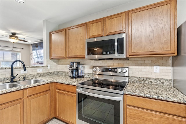 2124 Franks St, Fort Worth, TX 76177 - kitchen with stainless steel appliances, decorative backsplash, a ceiling fan, and light stone countertops