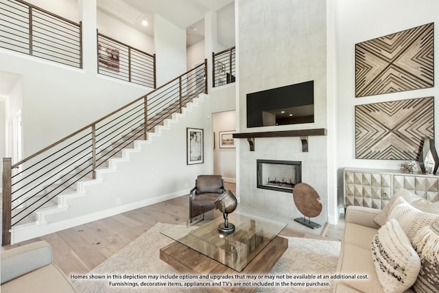 2301 Christopher Rd, Mansfield, TX 76063 - living area featuring a towering ceiling, stairway, wood finished floors, and a fireplace