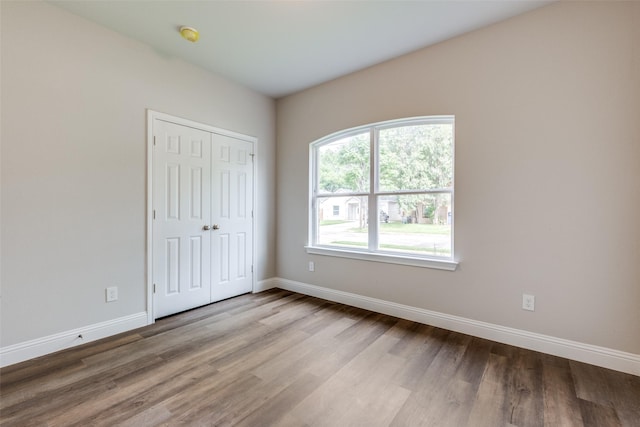 2726 Lawrence St, Dallas, TX 75215 - unfurnished bedroom with wood finished floors and a closet