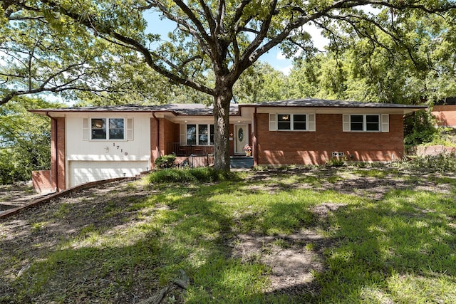 1719 W Day St, Denison, TX 75020 - view of front facade with brick siding, a garage, and a porch