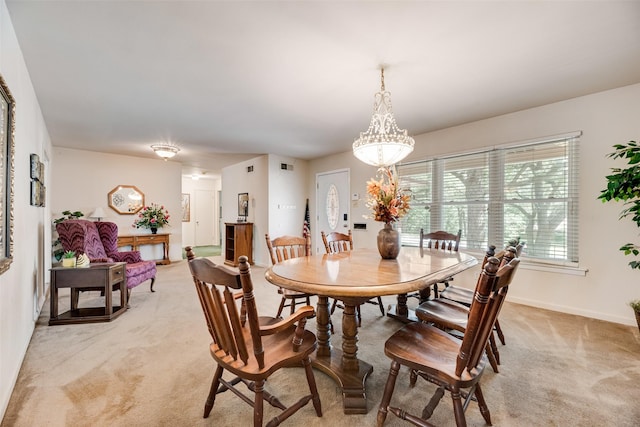 1719 W Day St, Denison, TX 75020 - dining room featuring light carpet and a chandelier