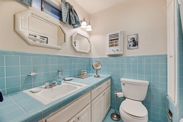 1719 W Day St, Denison, TX 75020 - bathroom featuring vanity, a wainscoted wall, tile walls, and heating unit