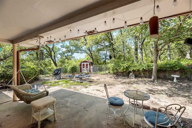1719 W Day St, Denison, TX 75020 - fenced backyard featuring a storage unit, a patio, and view of wooded area