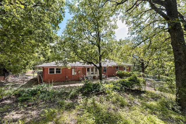 1719 W Day St, Denison, TX 75020 - back of house featuring a patio area