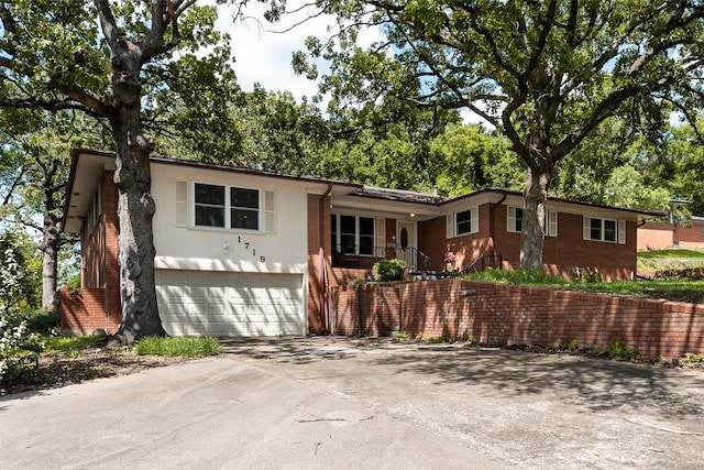 1719 W Day St, Denison, TX 75020 - single story home with concrete driveway, brick siding, and a garage