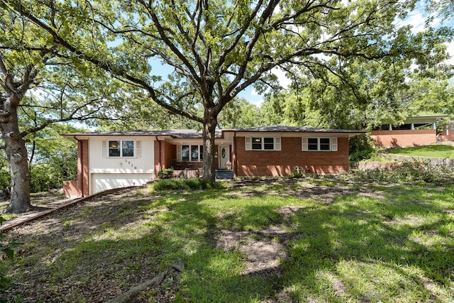 1719 W Day St, Denison, TX 75020 - ranch-style house featuring a garage