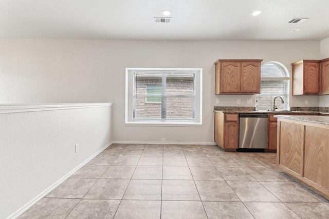 5901 Ozark Dr, Fort Worth, TX 76131 - kitchen with dishwasher, light tile patterned flooring, stone counters, recessed lighting, and brown cabinetry