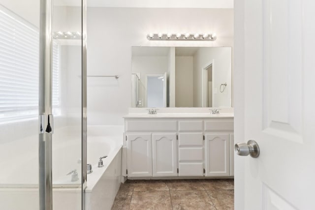 5901 Ozark Dr, Fort Worth, TX 76131 - bathroom featuring double vanity, a garden tub, a stall shower, and tile patterned floors
