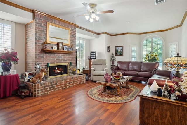 2031 Deepwood St, Mesquite, TX 75181 - living room featuring wood finished floors, a brick fireplace, healthy amount of natural light, and crown molding