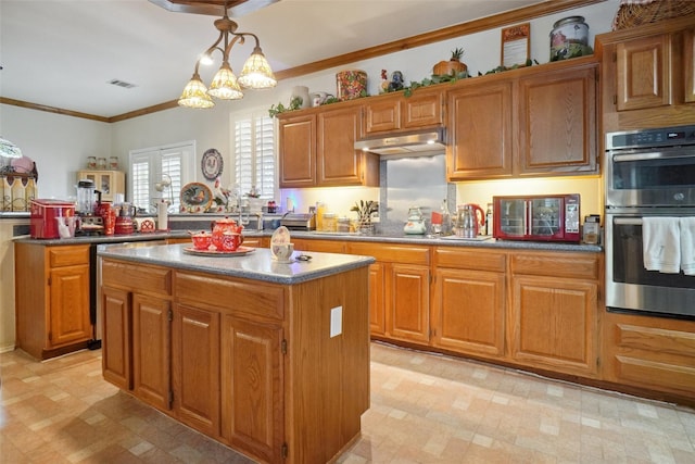 2031 Deepwood St, Mesquite, TX 75181 - kitchen with double oven, light floors, a center island, under cabinet range hood, and brown cabinets