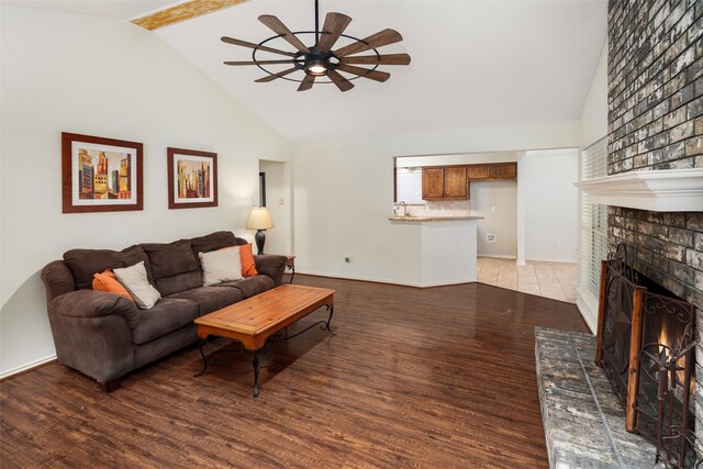 5723 Sachse St, Sachse, TX 75048 - living room featuring a ceiling fan, light wood-type flooring, high vaulted ceiling, a brick fireplace, and beamed ceiling