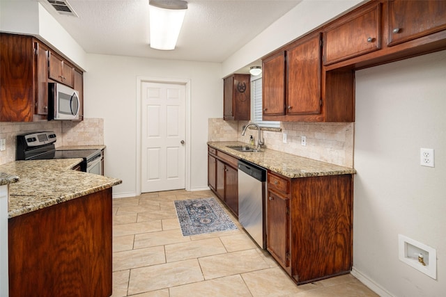 5723 Sachse St, Sachse, TX 75048 - kitchen with appliances with stainless steel finishes, tasteful backsplash, light stone counters, and light tile patterned floors