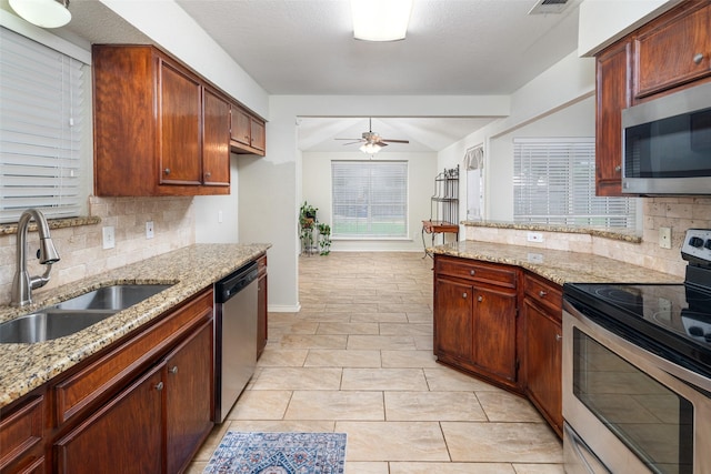 5723 Sachse St, Sachse, TX 75048 - kitchen featuring stainless steel appliances, a ceiling fan, decorative backsplash, and light stone countertops