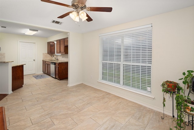 5723 Sachse St, Sachse, TX 75048 - kitchen with dishwasher, ceiling fan, and light stone counters