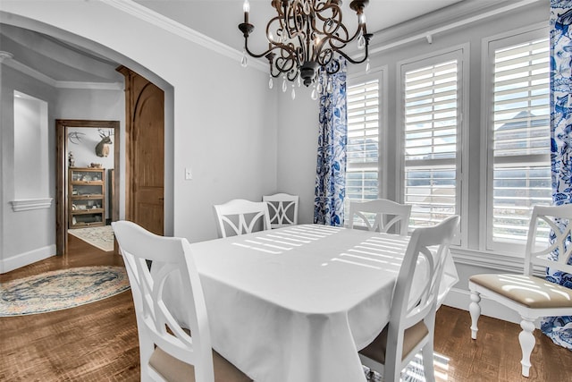 2911 Butterfield Trl, Sherman, TX 75092 - dining area featuring arched walkways, crown molding, a chandelier, and wood finished floors