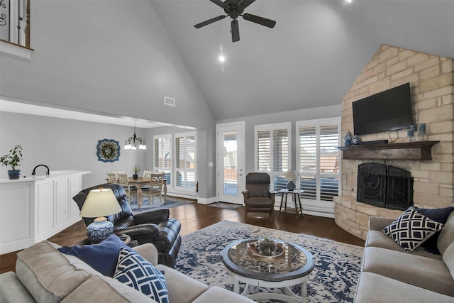 2911 Butterfield Trl, Sherman, TX 75092 - living area with high vaulted ceiling, a stone fireplace, ceiling fan, dark wood-type flooring, and a chandelier