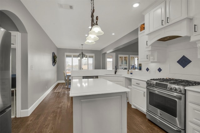 2911 Butterfield Trl, Sherman, TX 75092 - kitchen with appliances with stainless steel finishes, light countertops, a kitchen island, a peninsula, and dark wood-style flooring