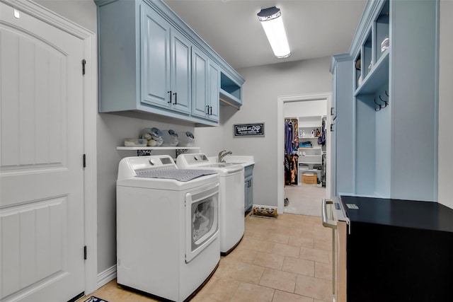2911 Butterfield Trl, Sherman, TX 75092 - washroom featuring washing machine and dryer, cabinet space, and light tile patterned flooring