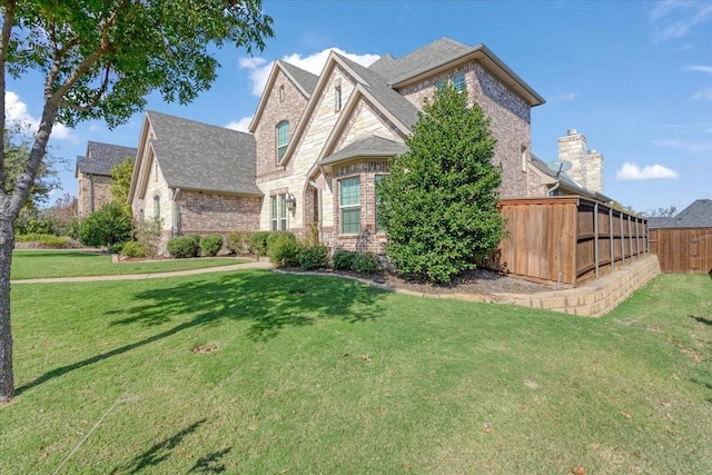 2911 Butterfield Trl, Sherman, TX 75092 - french country style house featuring brick siding and roof with shingles