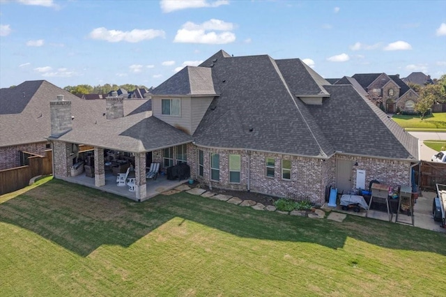 2911 Butterfield Trl, Sherman, TX 75092 - rear view of house with a patio area, roof with shingles, a fenced backyard, and brick siding