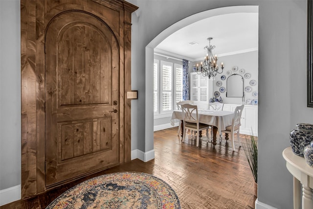 2911 Butterfield Trl, Sherman, TX 75092 - entrance foyer featuring arched walkways, a chandelier, wood finished floors, and crown molding