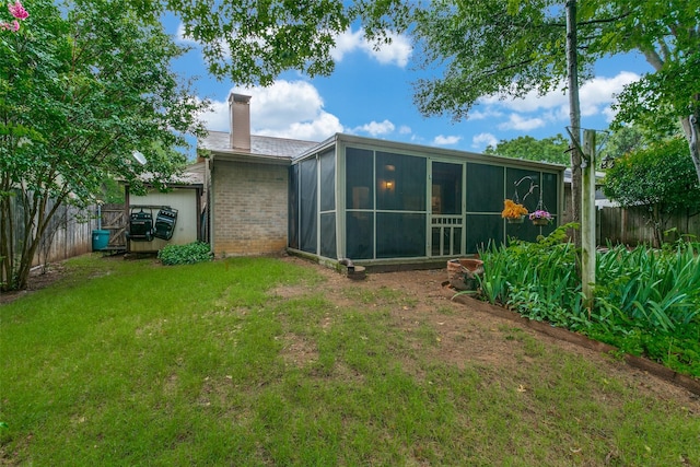 5312 Vermillion Trl, Arlington, TX 76017 - rear view of house with a chimney, a sunroom, and brick siding